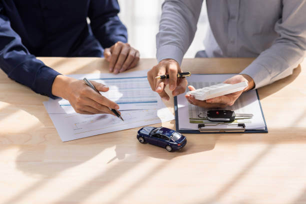 Driver reviewing a car insurance policy and comparing premium costs